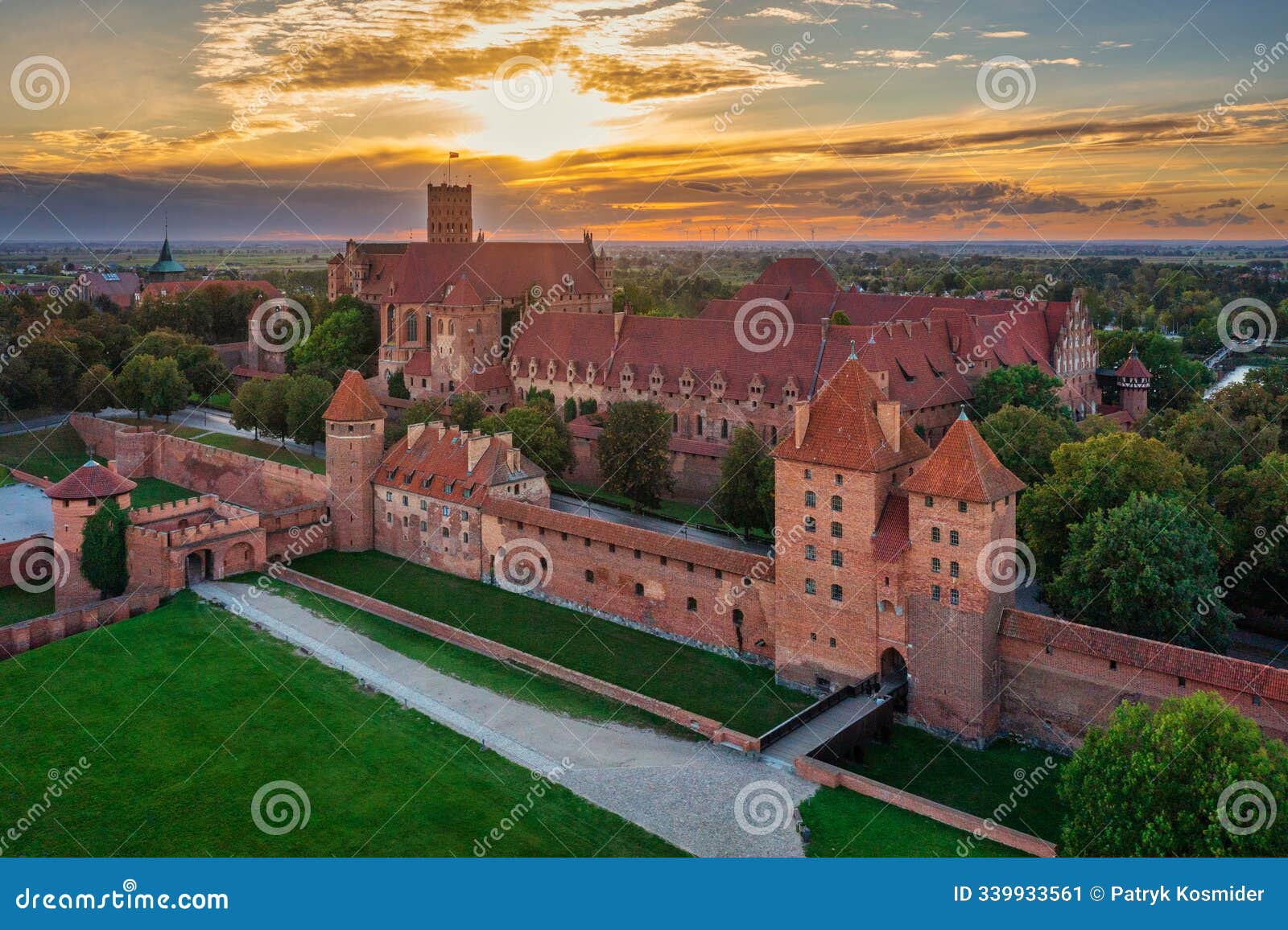 castle of theteutonic order in malbork by the nogat river at sunset