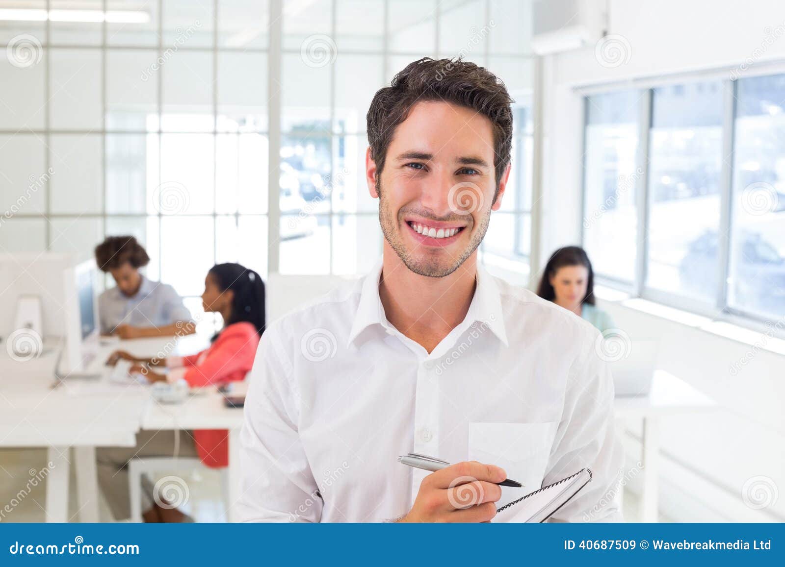 Casual Businessman Taking Notes Smiling at Camera Stock Image Image