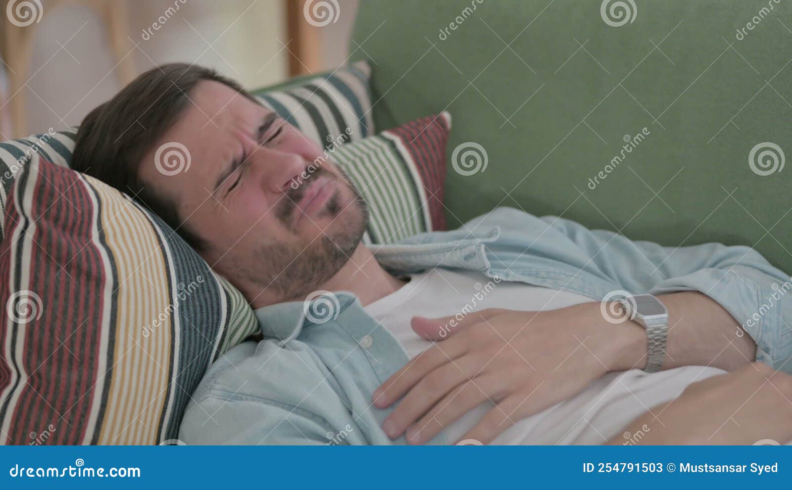 Close Up of Young Man Coughing while Lying on Sofa Stock Video Video