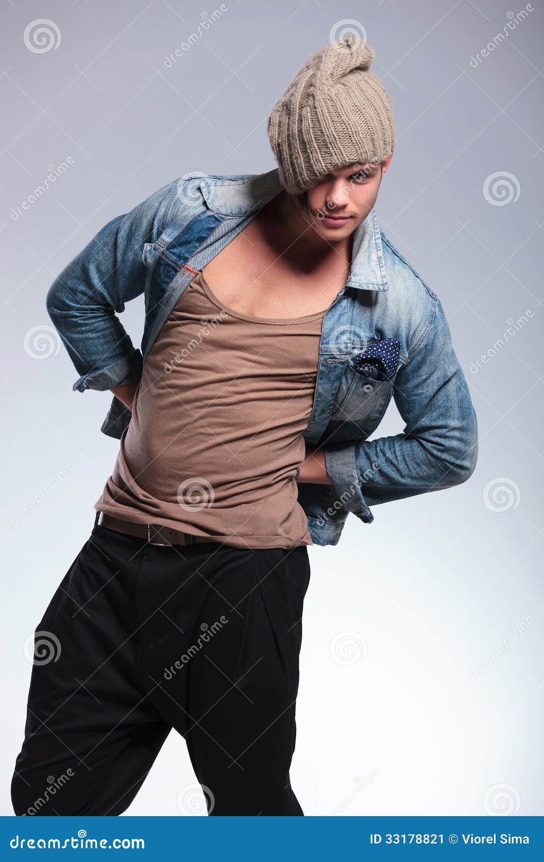 Casual Man With Hands On Hips And Hat Stock Image - Image 