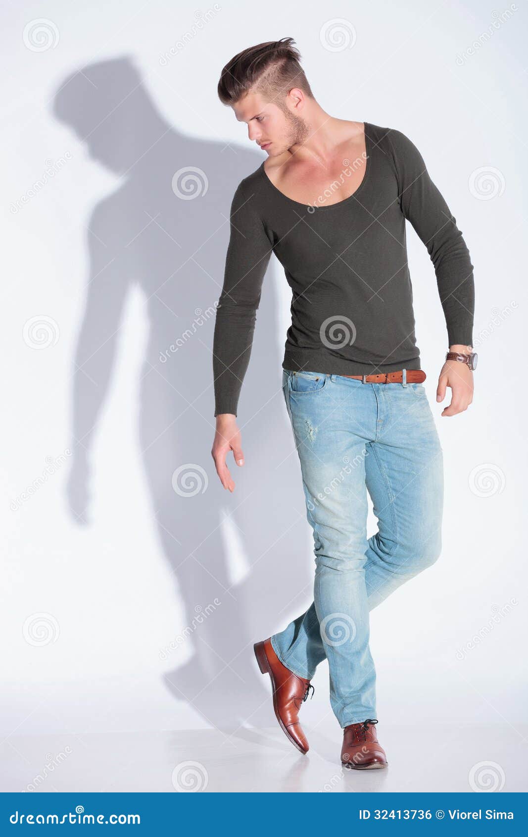 Fit male model posing on dark background stock photo - OFFSET