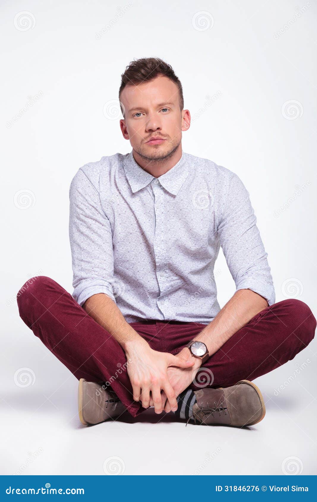 Casual Man Sits With Legs Crossed Stock Photo - Image: 31846276