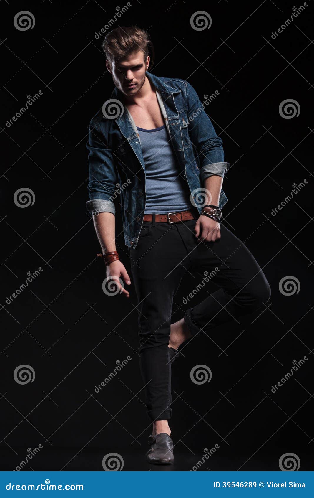 casual man standing one leg fashion pose young clothes studio 39546289