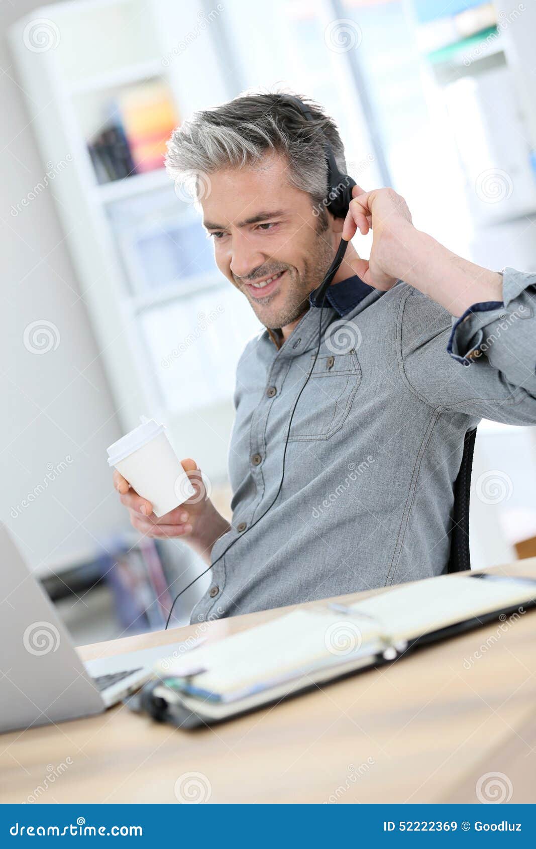 casual mature man teleworking from home with laptop