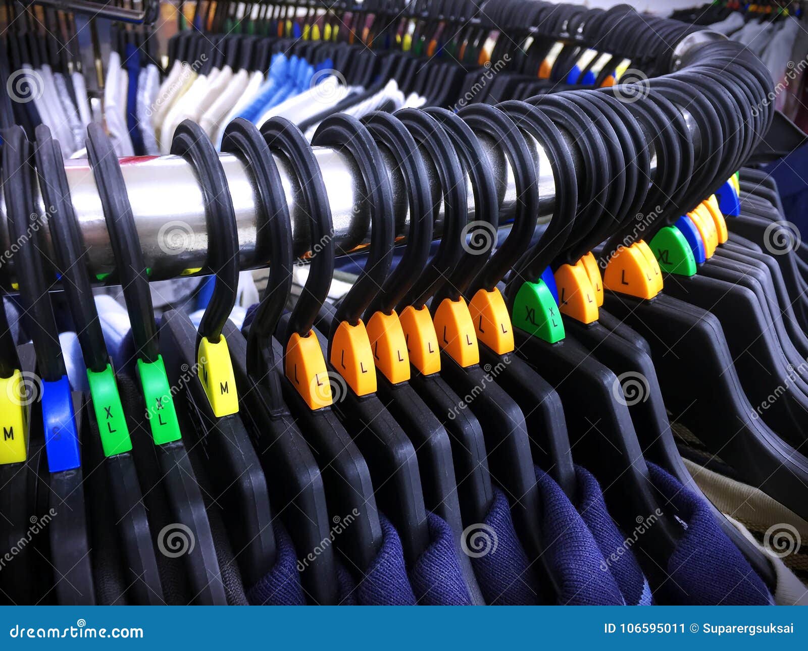 Casual Shirts on Hangers with Size Letter Labels on Curved Steel Rack ...