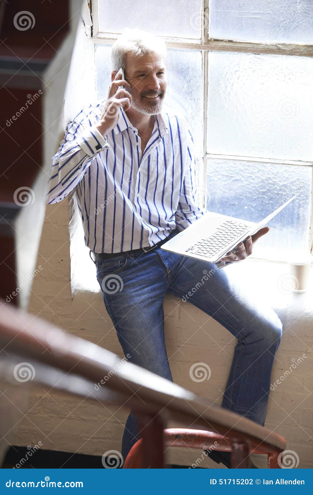 casually dressed businessman working on stairs in office