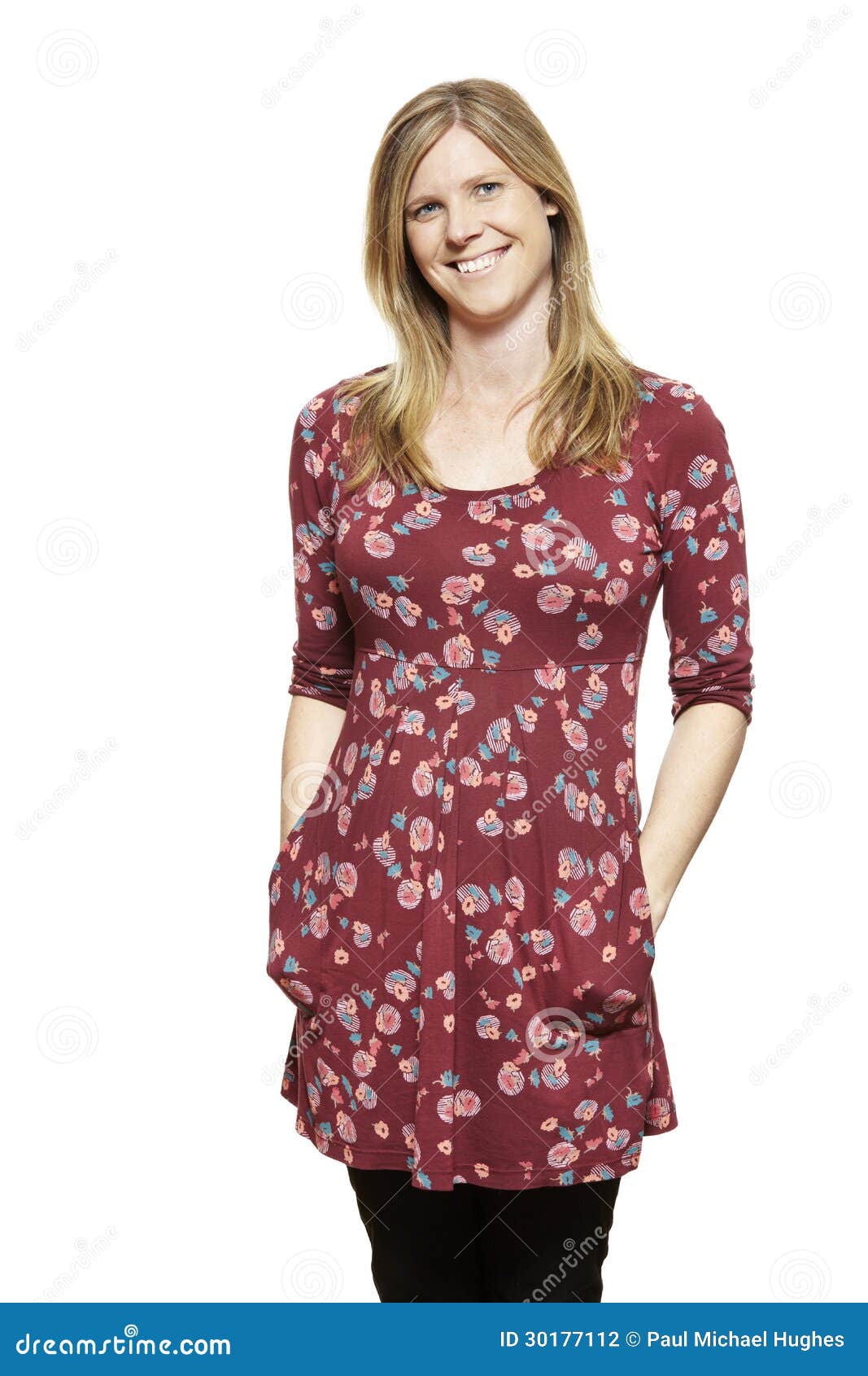 casually dressed young pregnant woman smiling
