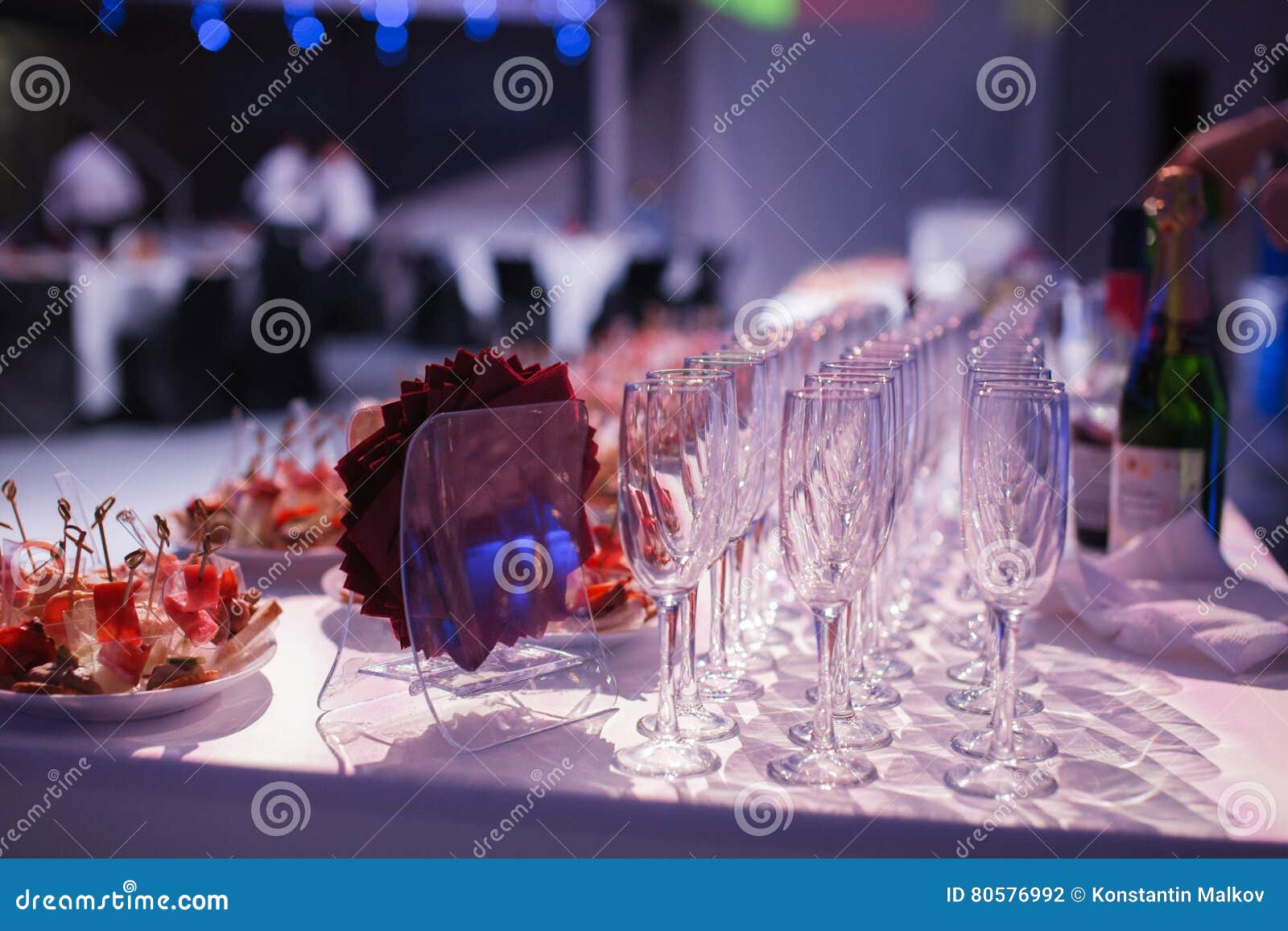 catering banquet table with baked food snacks, sandwiches, cakes, cups and plates, self serve, open buffet dinner