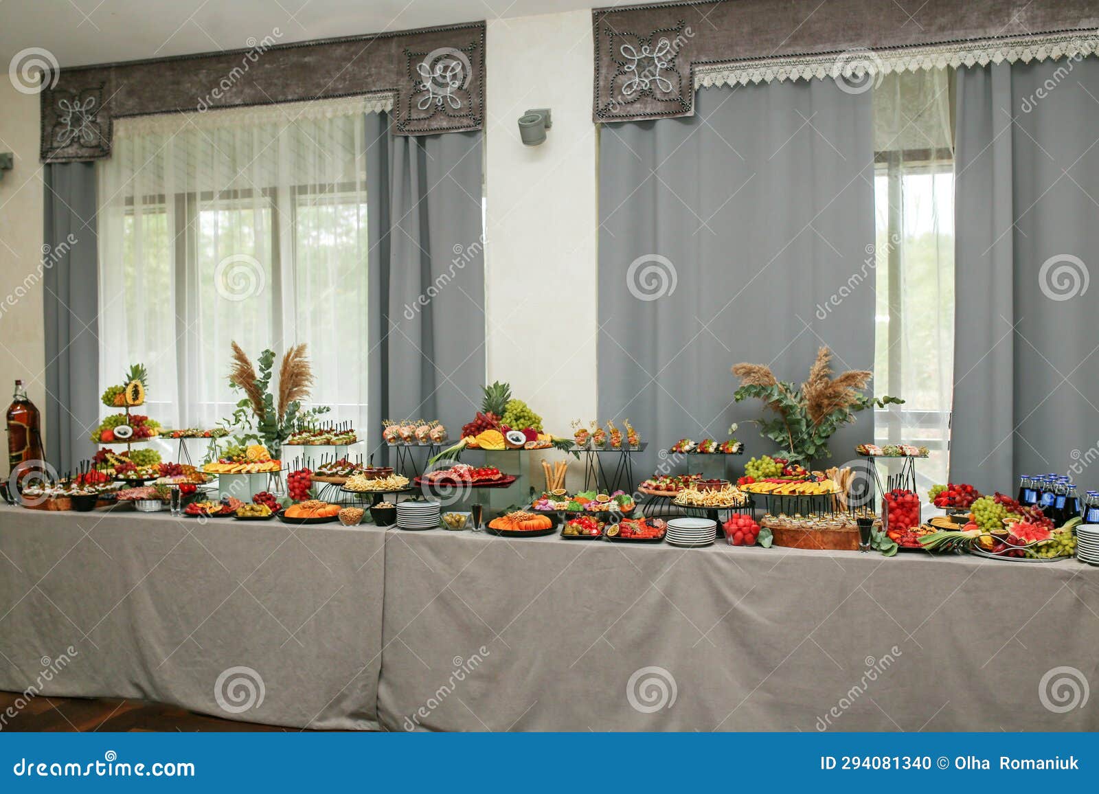 catering buffet table with snacks and appetizers. set of varios fruits and berries. decorative vase