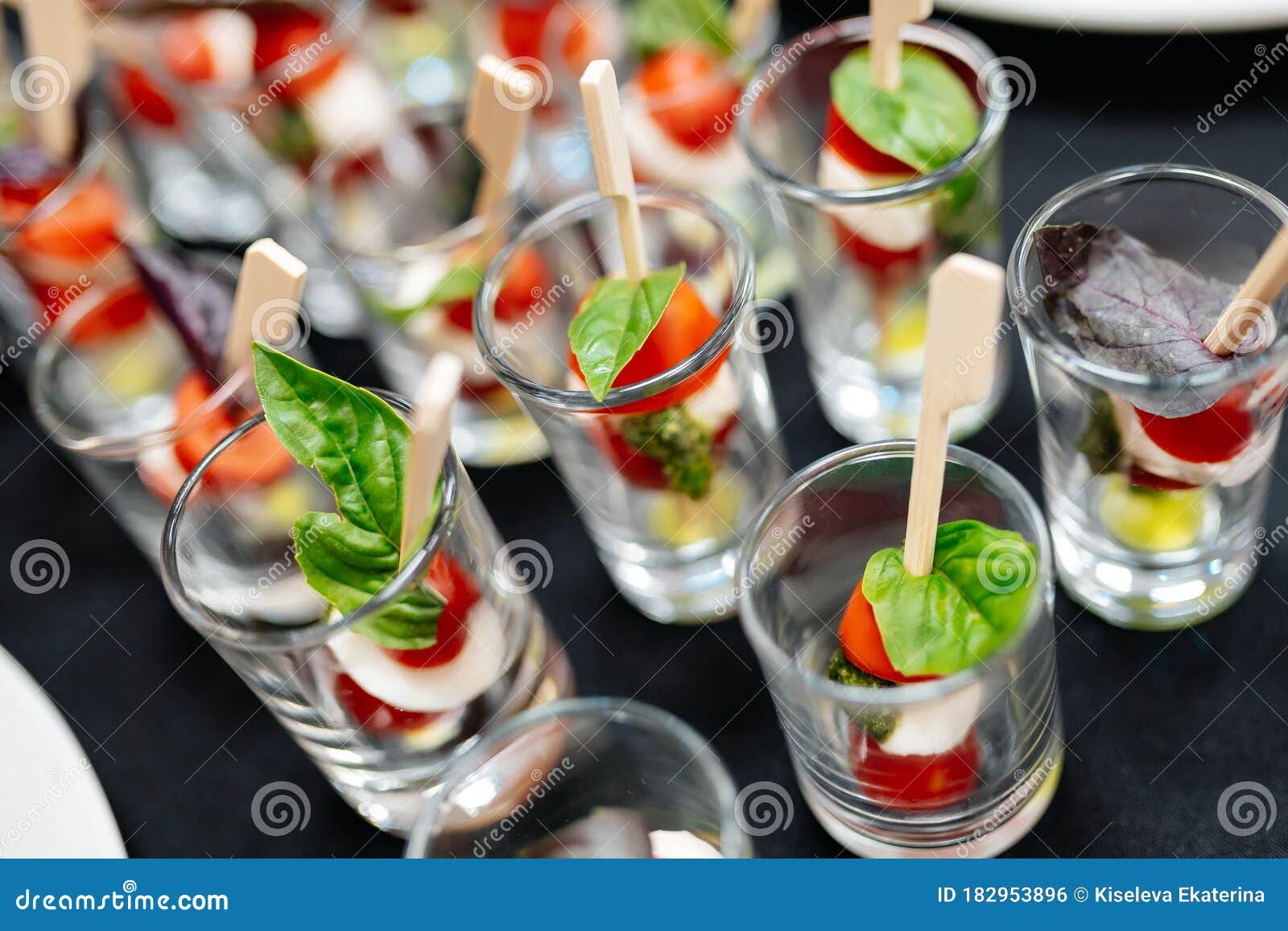 Catering. Canapes with Cherry Tomatoes and Basil Leaf. Stock Photo