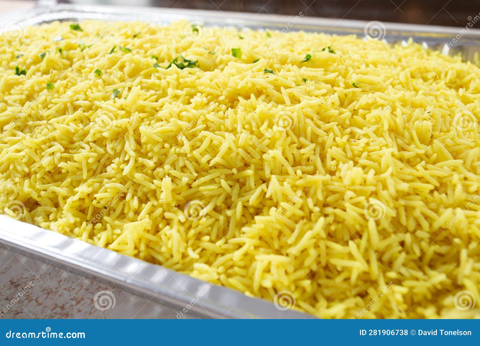 Catering Size Container of Mediterranean Yellow Rice Stock Photo