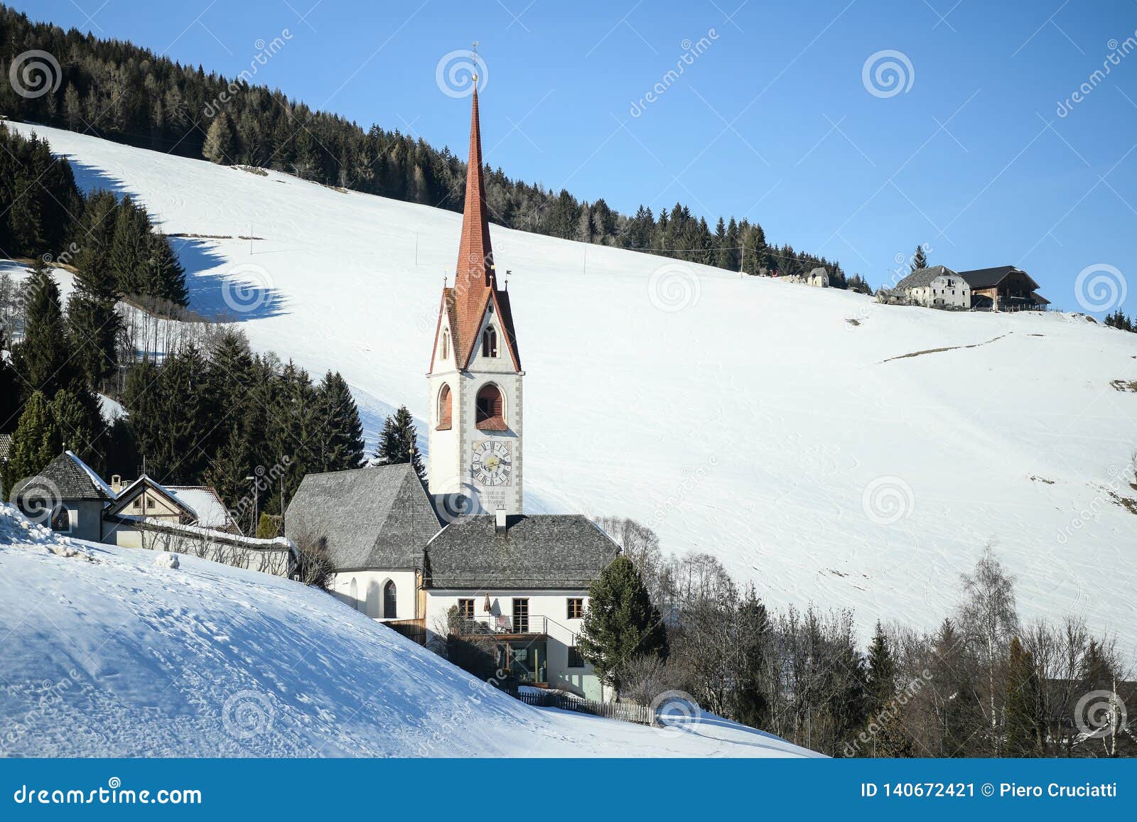 catholic church in the italian dolomites in wintertime with snow.
