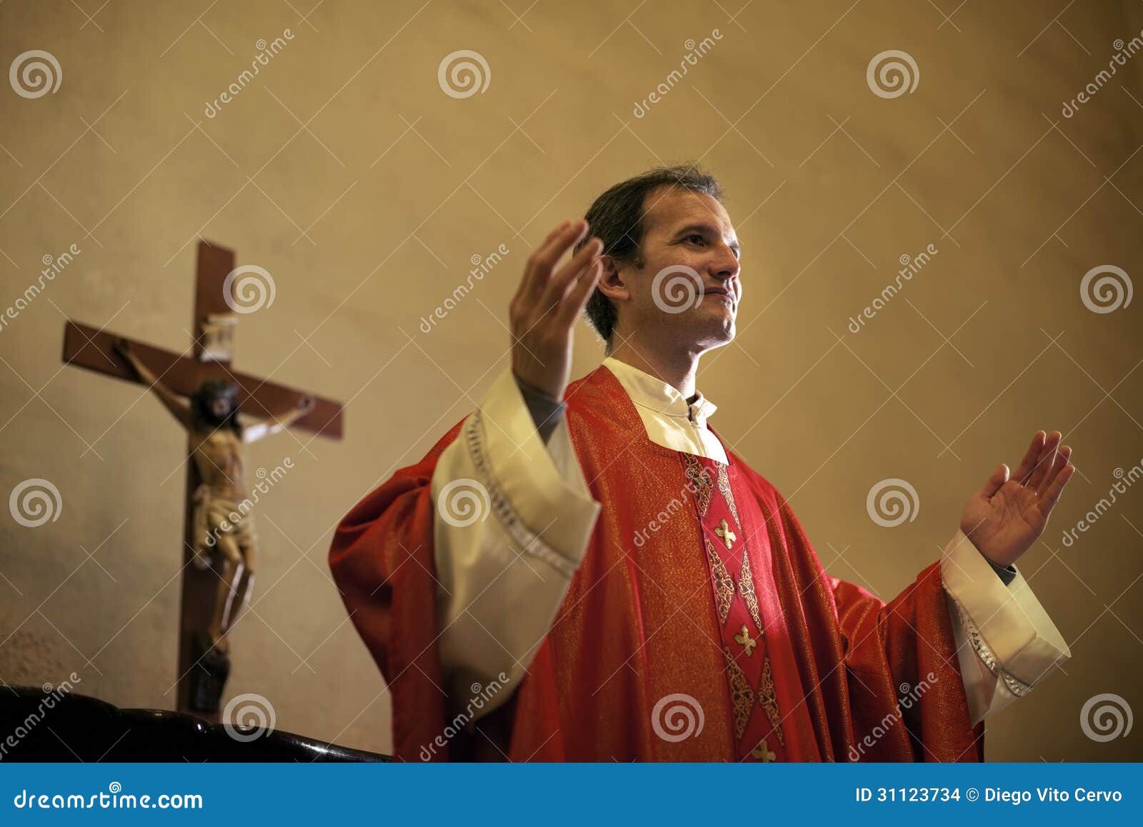 catholic priest on altar praying during mass