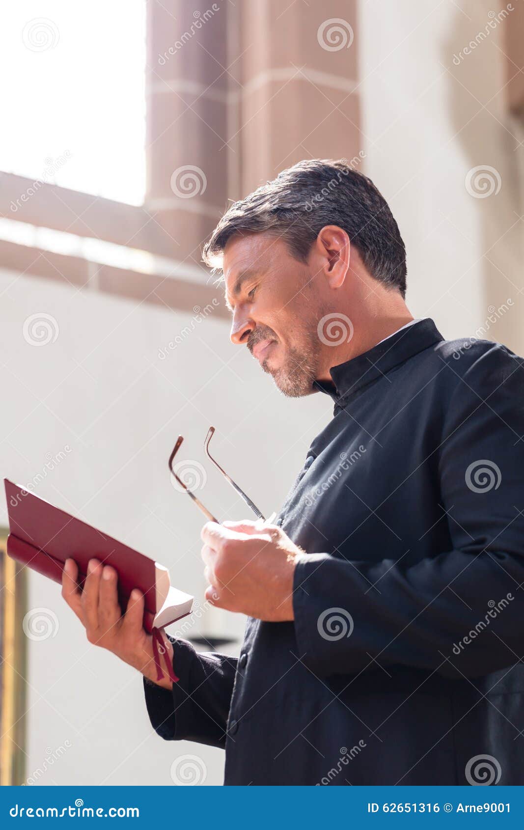 Catholic Priest Reading Bible In Church Stock Photo Image 62651316