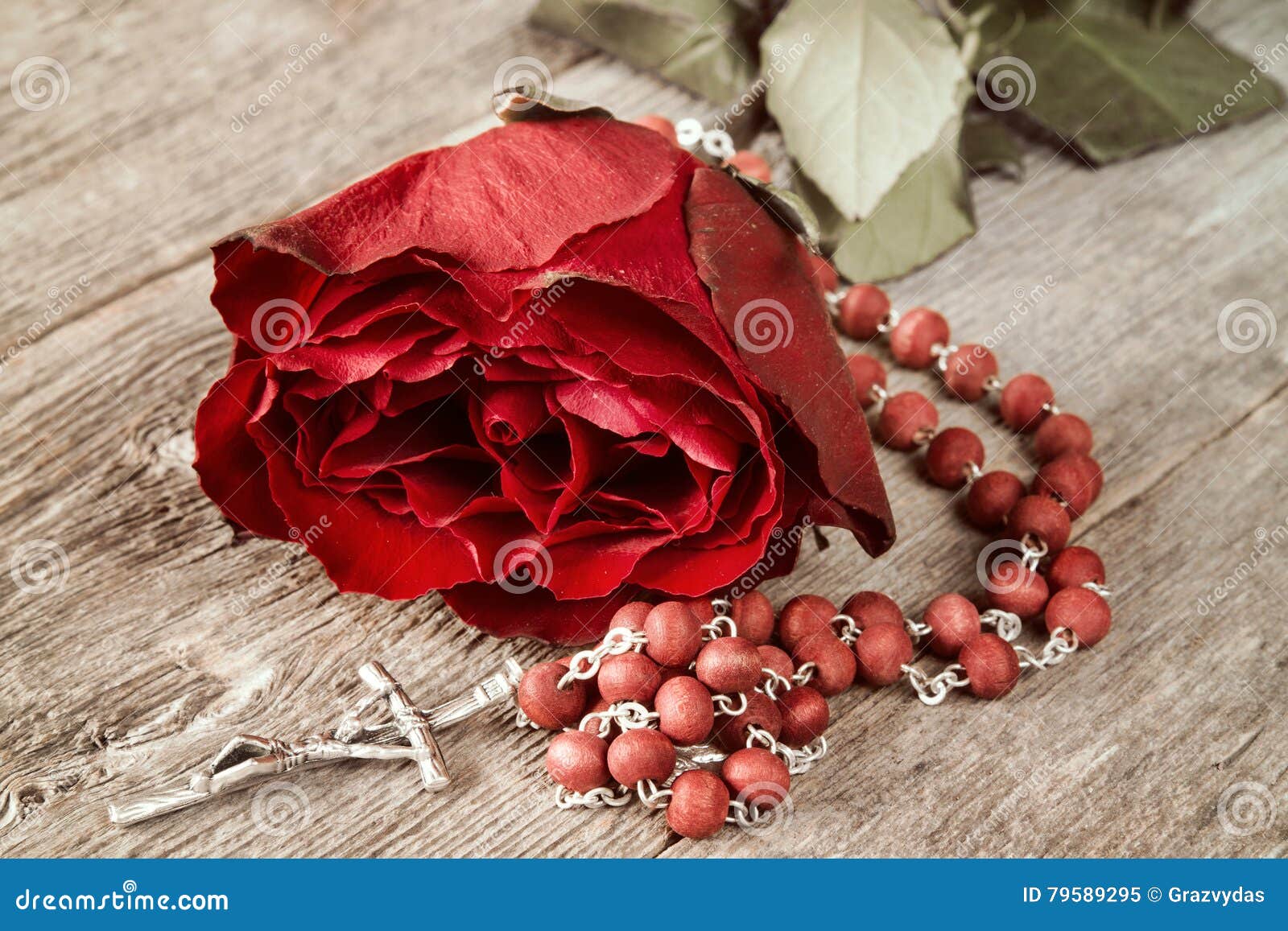 catholic rosary and red rose