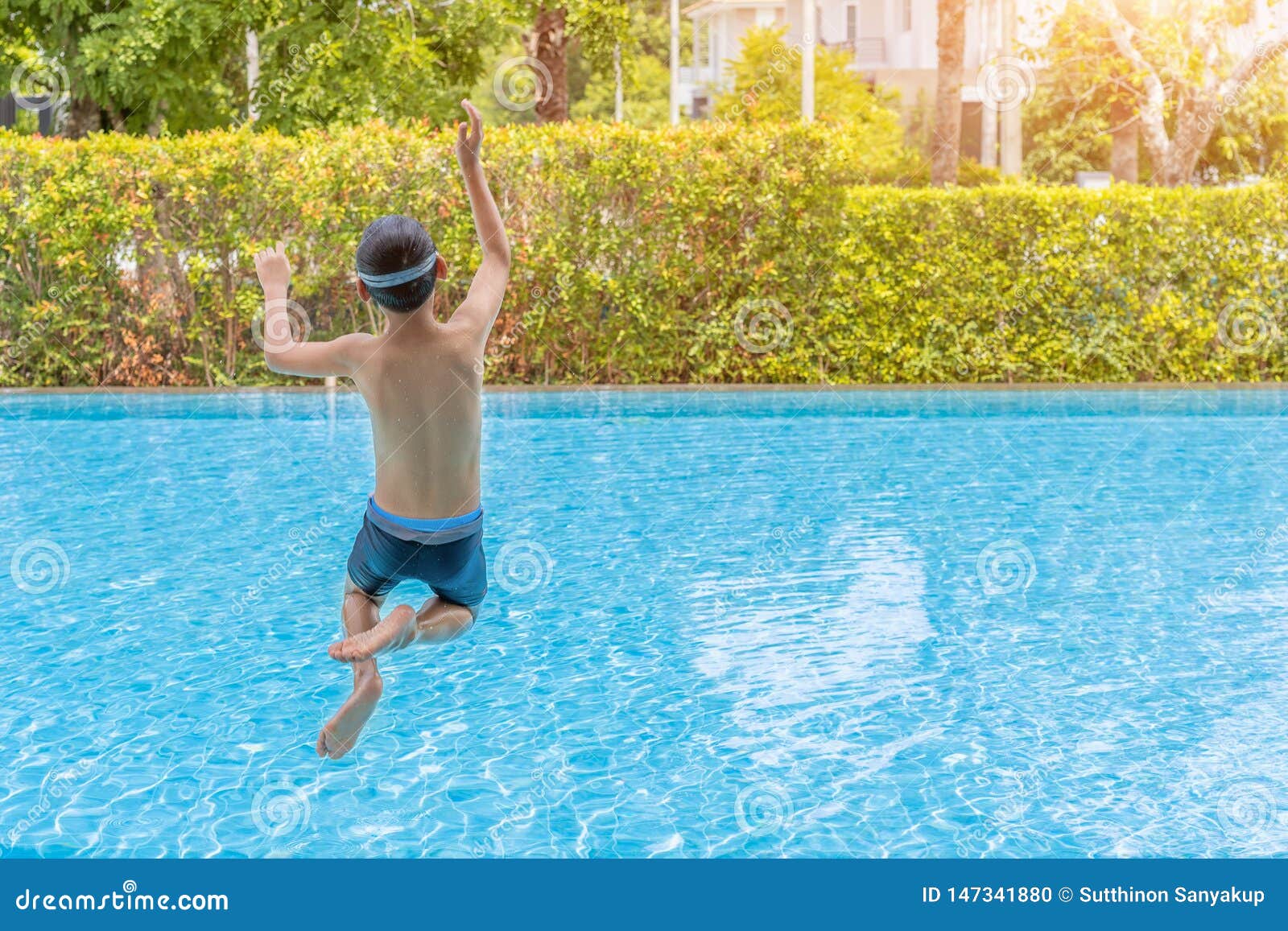 Caucasian Boy Having Fun Jumping Into The Pool Happy Boy Kid Jumping