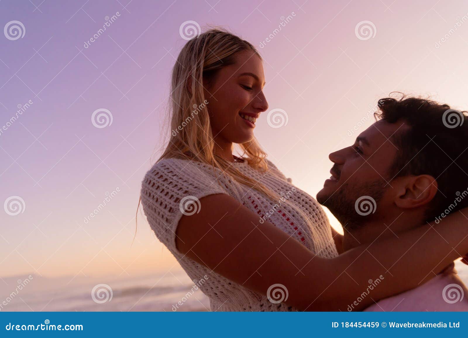 Caucasian Couple Enjoying Time At The Beach During The Sunset Stock Image Image Of Woman