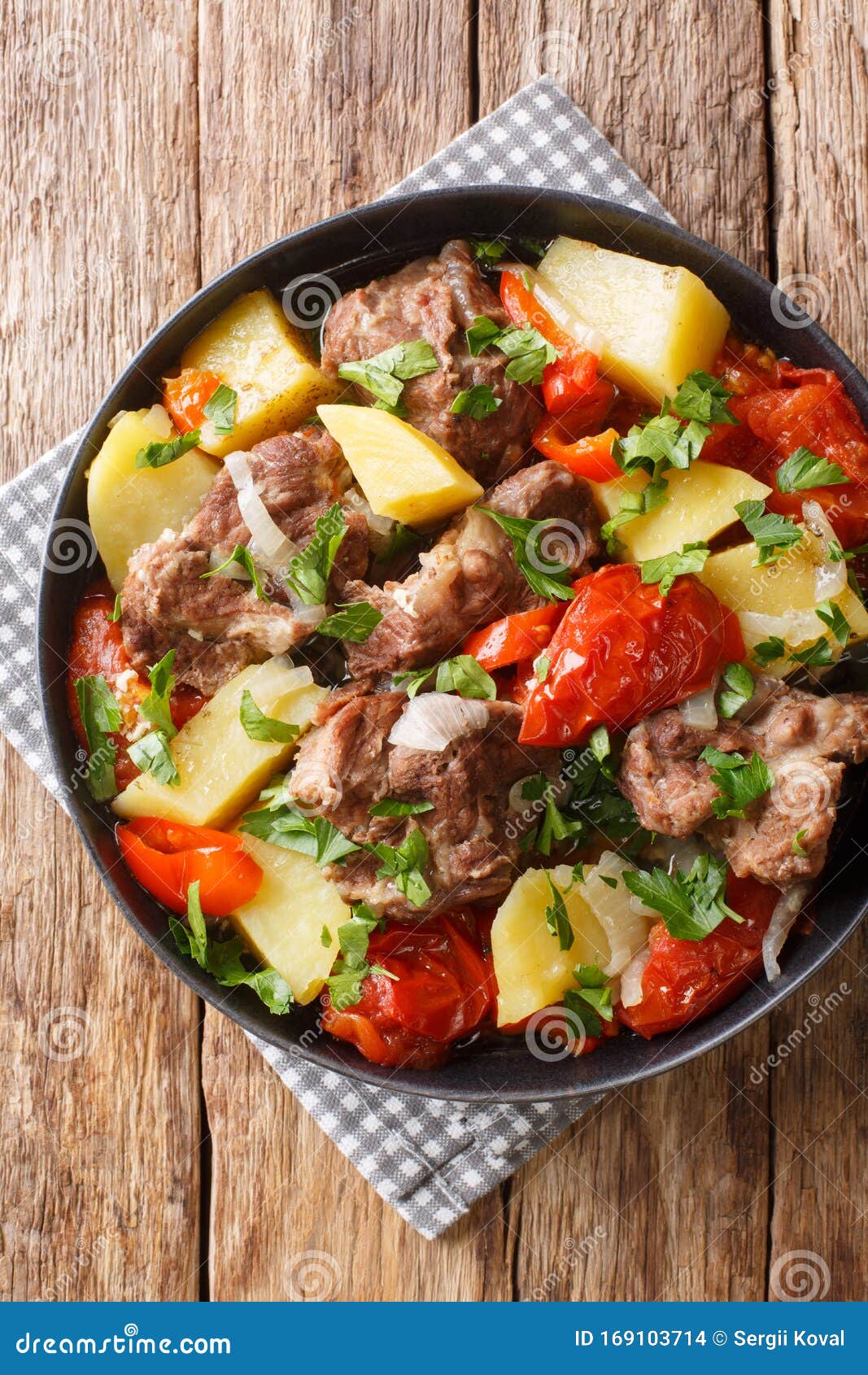 caucasian cuisine khashlama slowly stew with vegetables close-up in a bowl. vertical top view