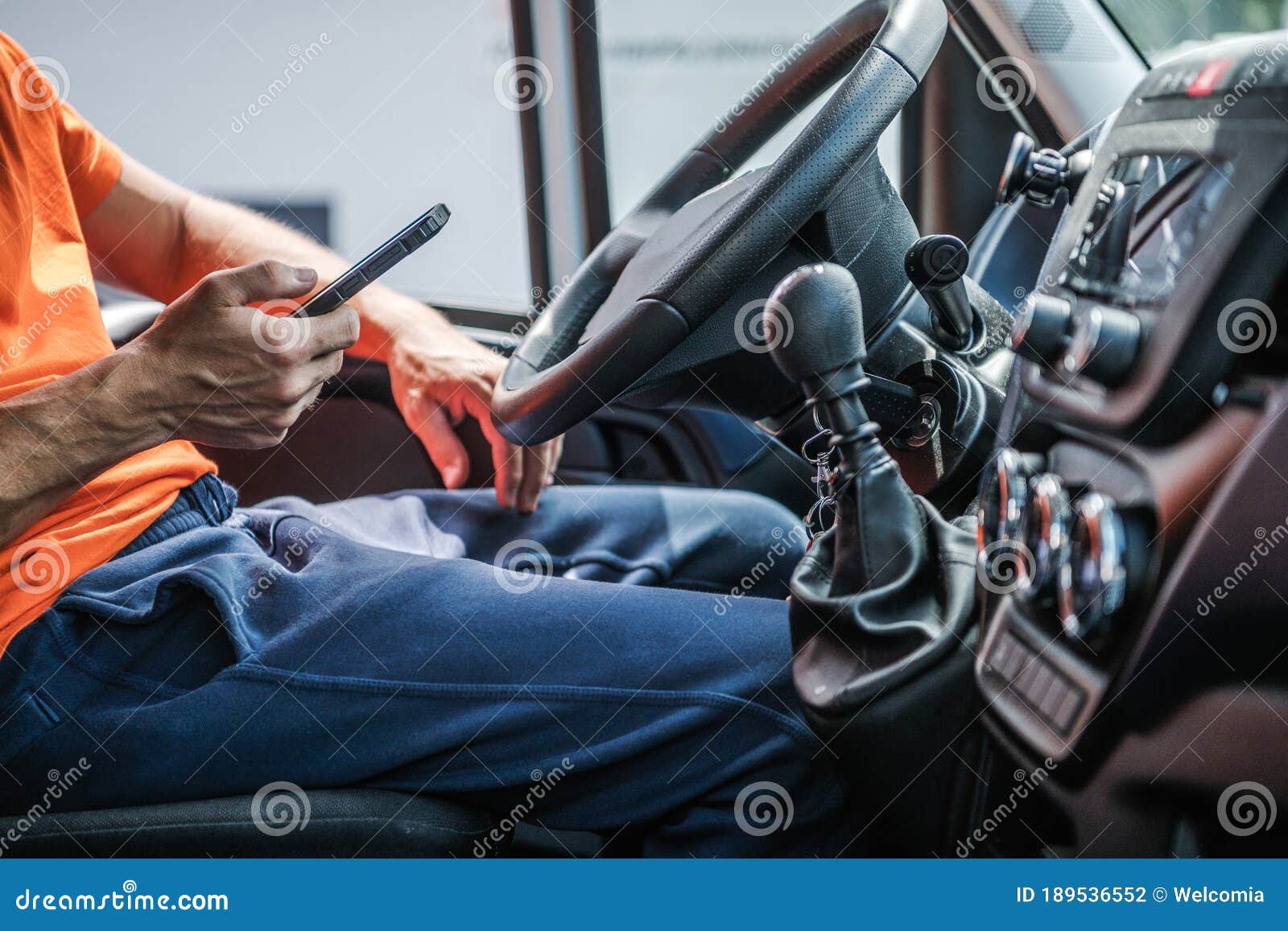 delivery truck driver browsing internet using his smartphone