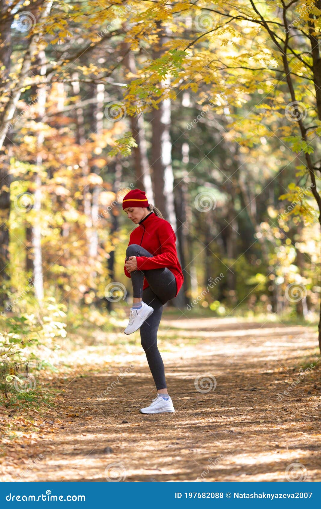 Caucasian Fit Woman in Red Sportswear and a Cap Warning Up Her Knees ...