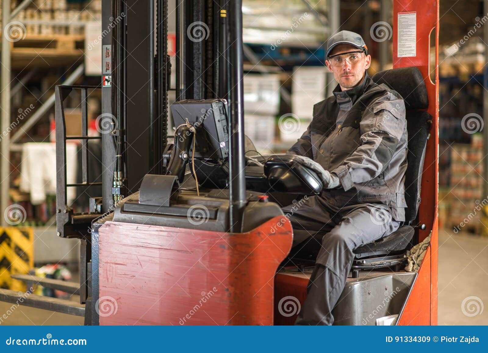 caucasian fork lift truck driver waiting for delivery.