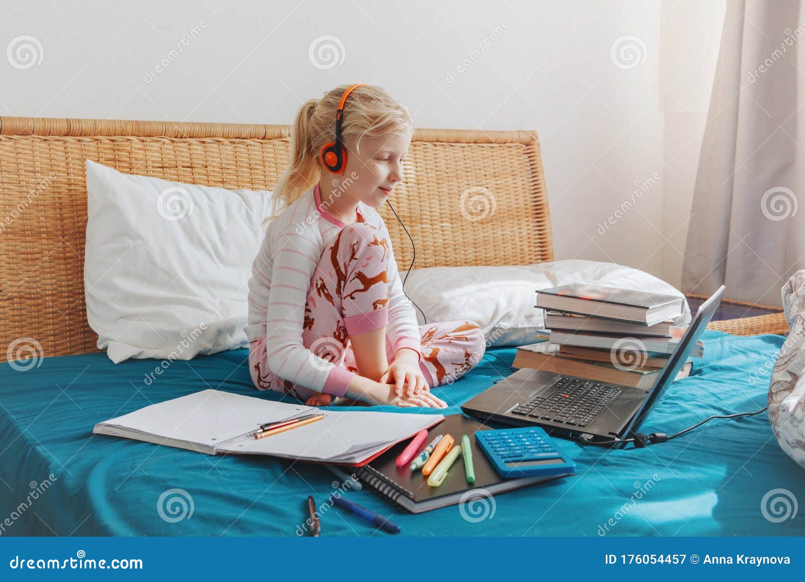 Caucasian Girl Child Sitting In A Bed And Learning Online On Laptop