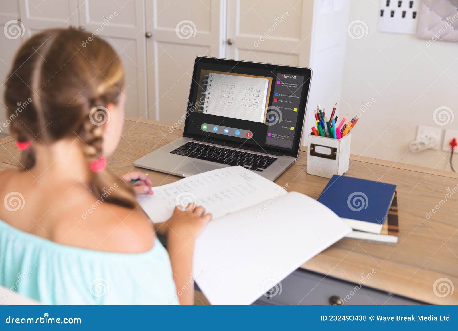 caucasian girl using laptop for video call, with class on screen