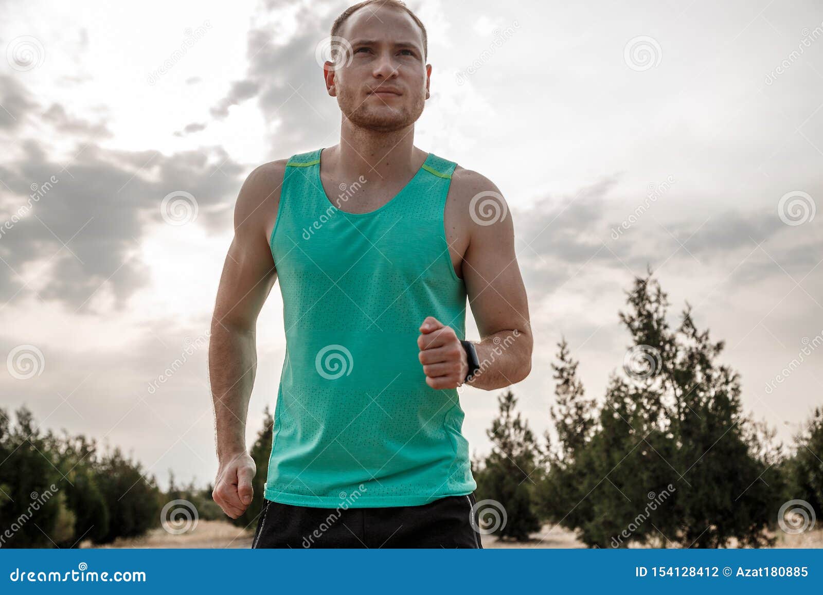 Caucasian Guy in a Blue T-shirt and Black Shorts,running Over Rough ...