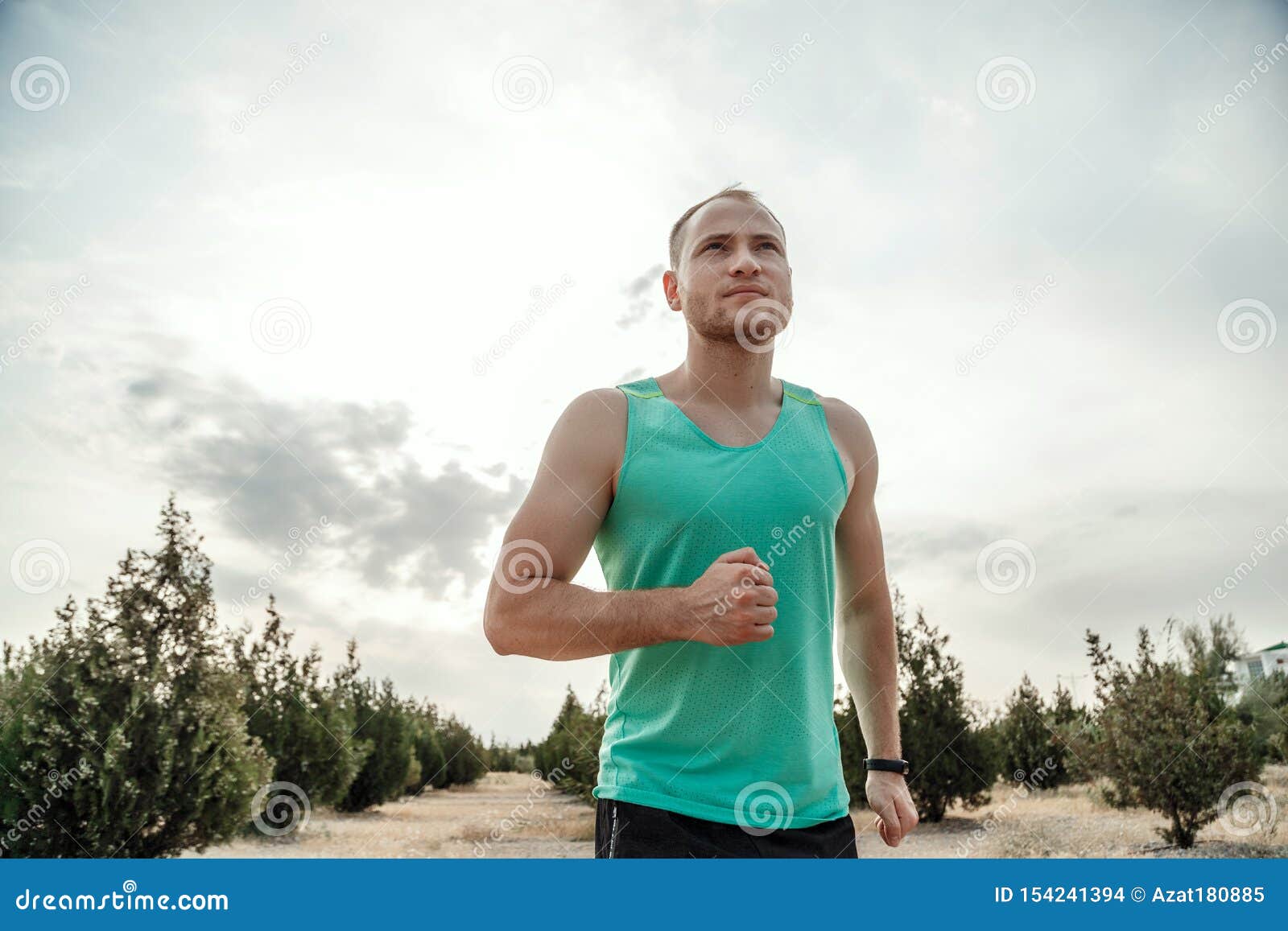 Caucasian Guy in a Blue T-shirt and Black Shorts,running Over Rough ...