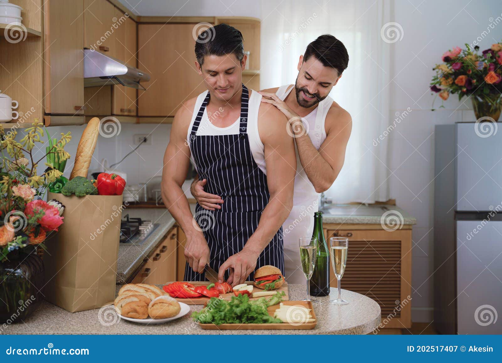 Caucasian Lgbtq Gay Couple Enjoying Cooking Food Together In Kitchen 