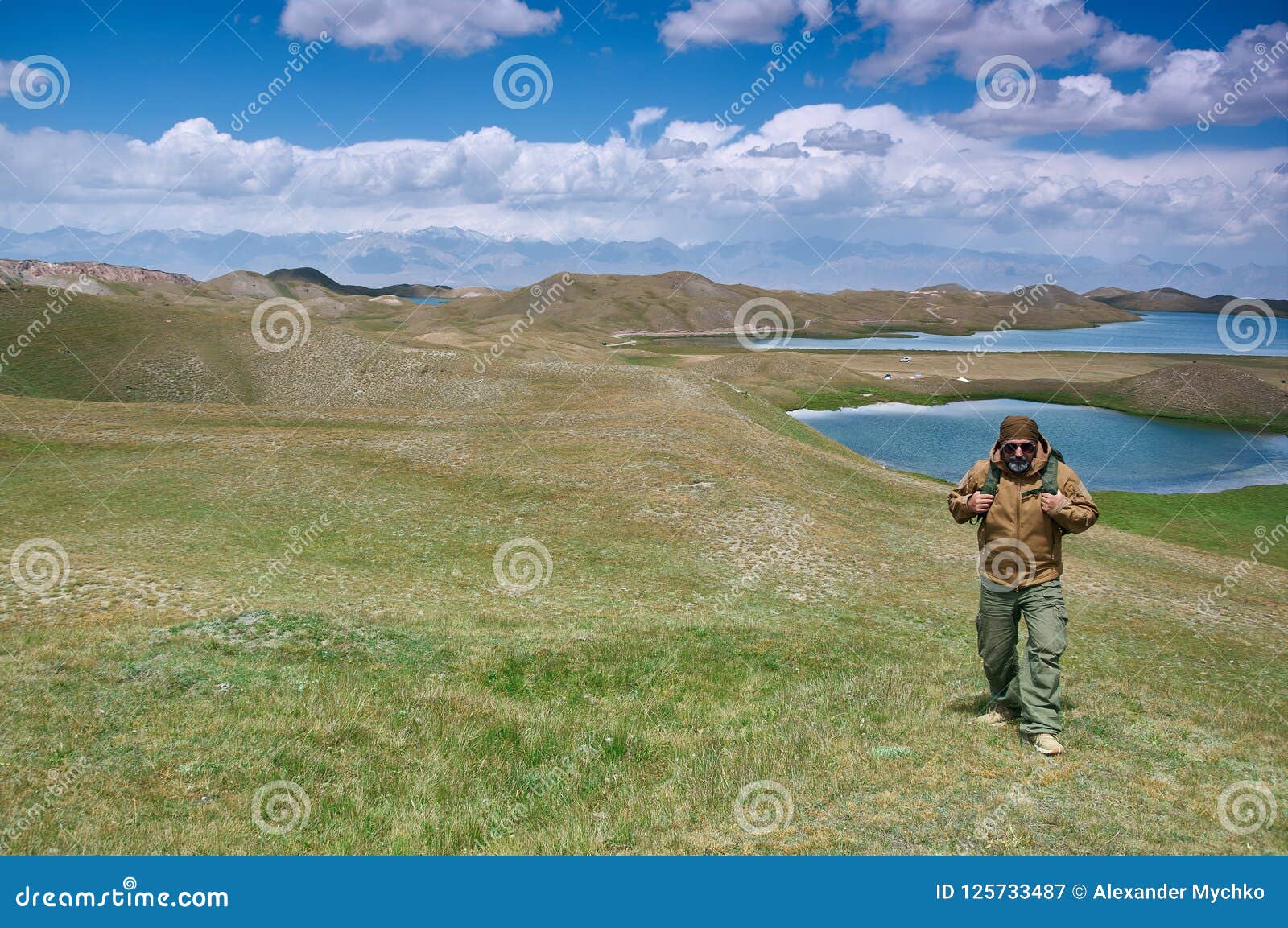 caucasian man with backpacks view from p pamir