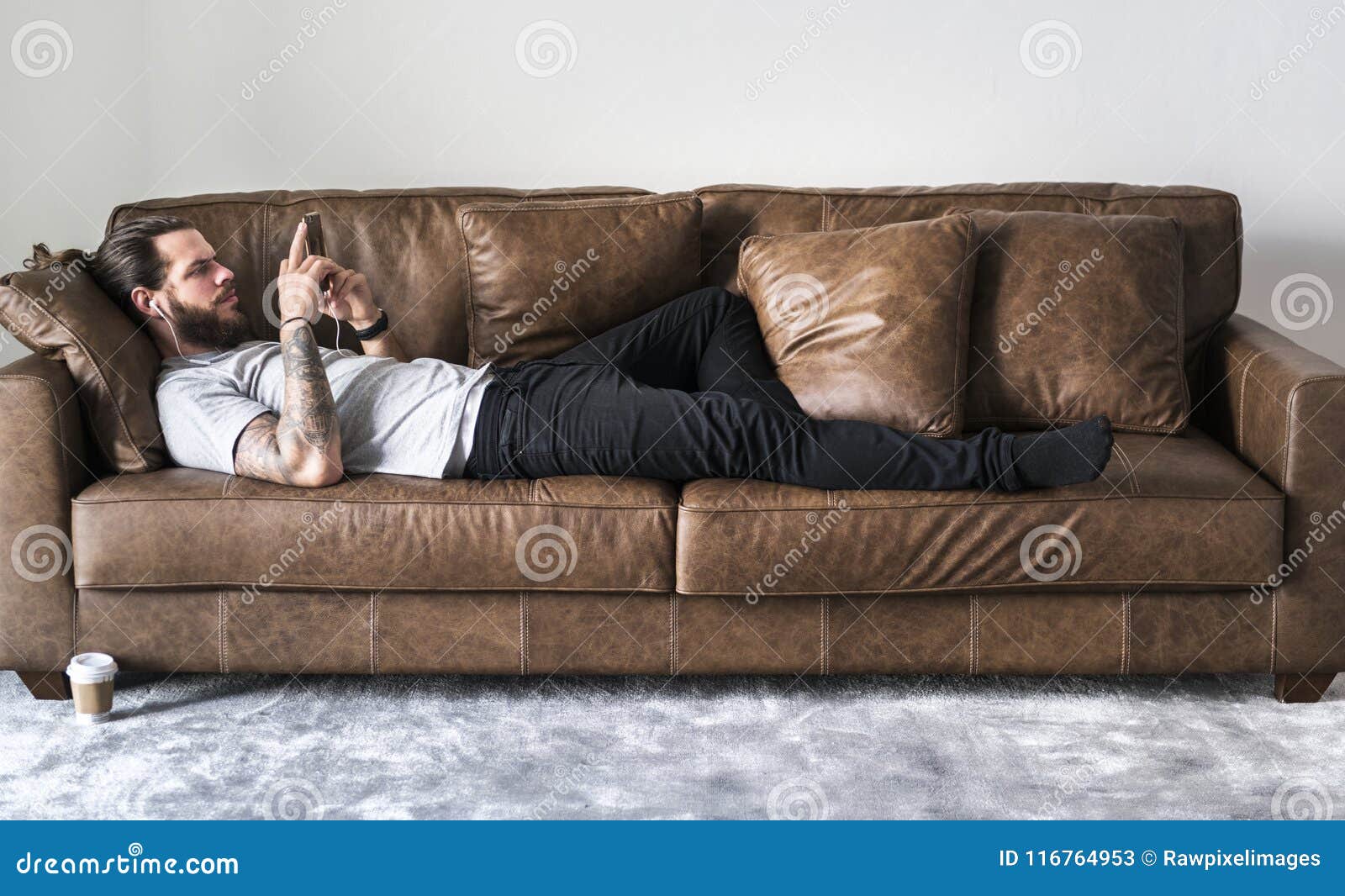 Caucasian Man Listening To Music on a Couch Stock Image - Image of ...