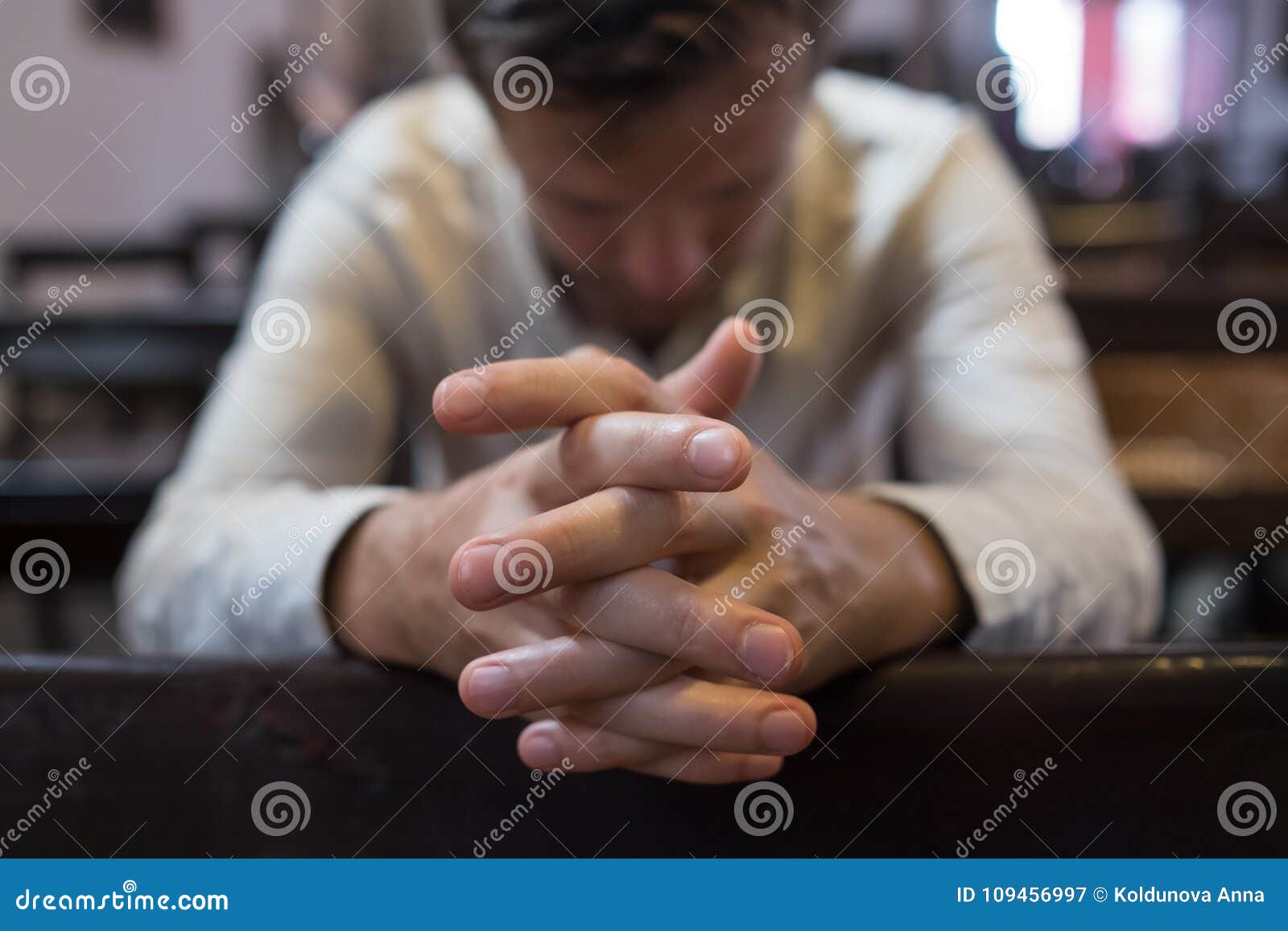caucasian man praying in church. he has problems and ask god for help