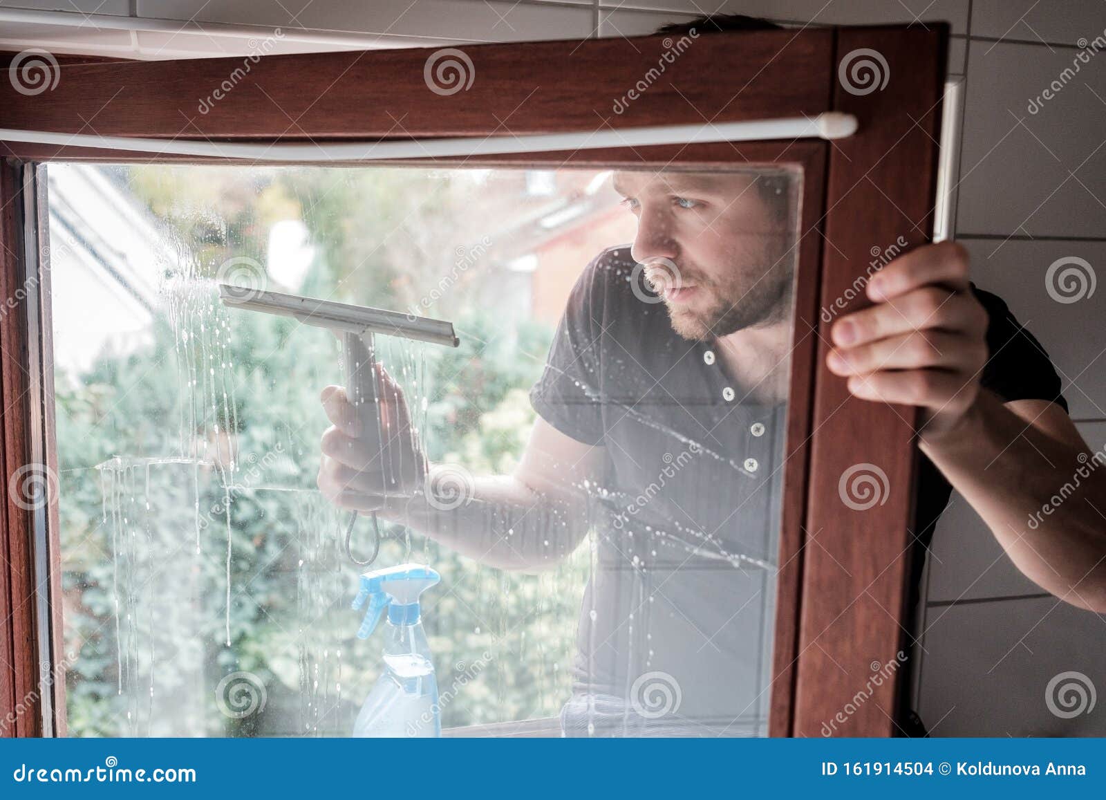 Man Washes a Window in a House Using Scraper Stock Photo Image of