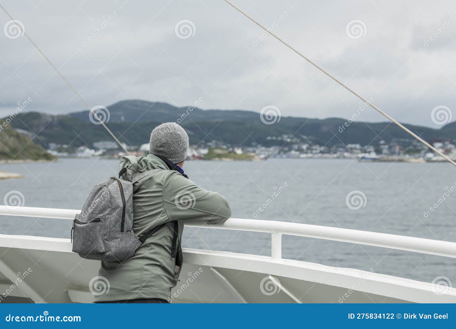 caucasian tourist standing on the deck on a ferry watching the arrival in bodÃ¸,