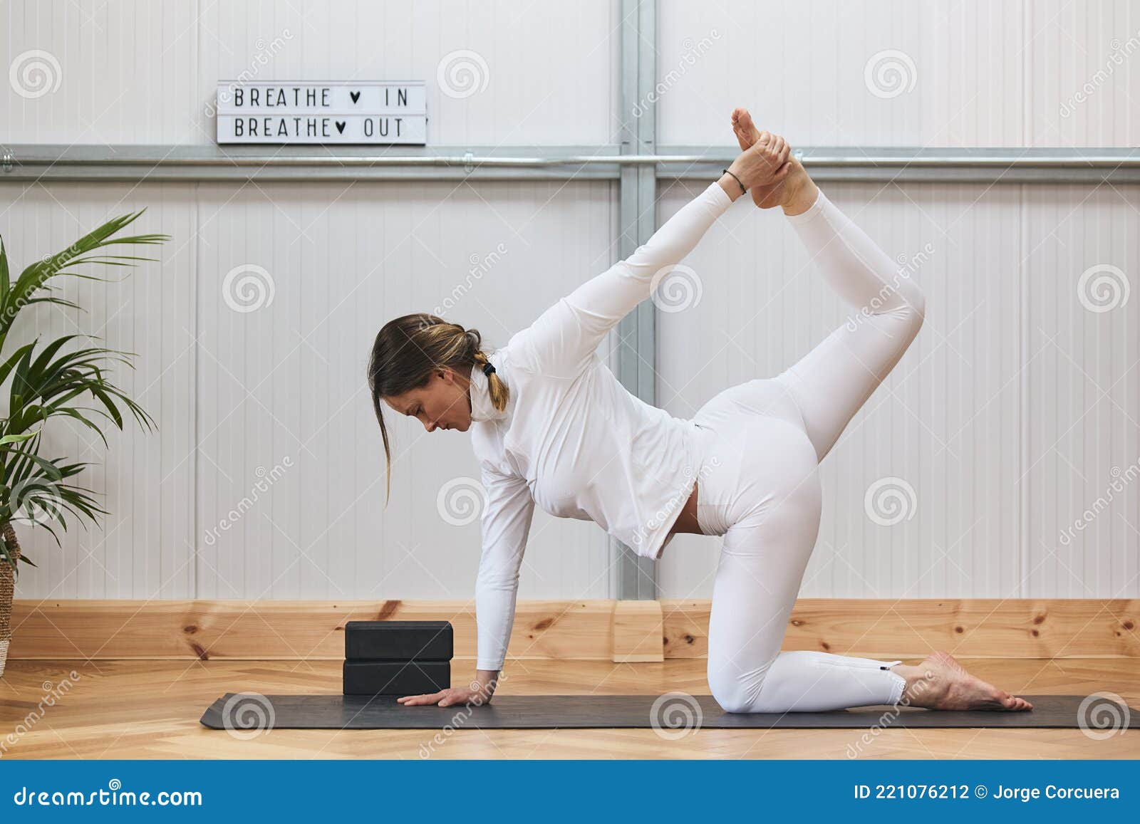 caucasian woman practicing yoga with a lot of elasticity