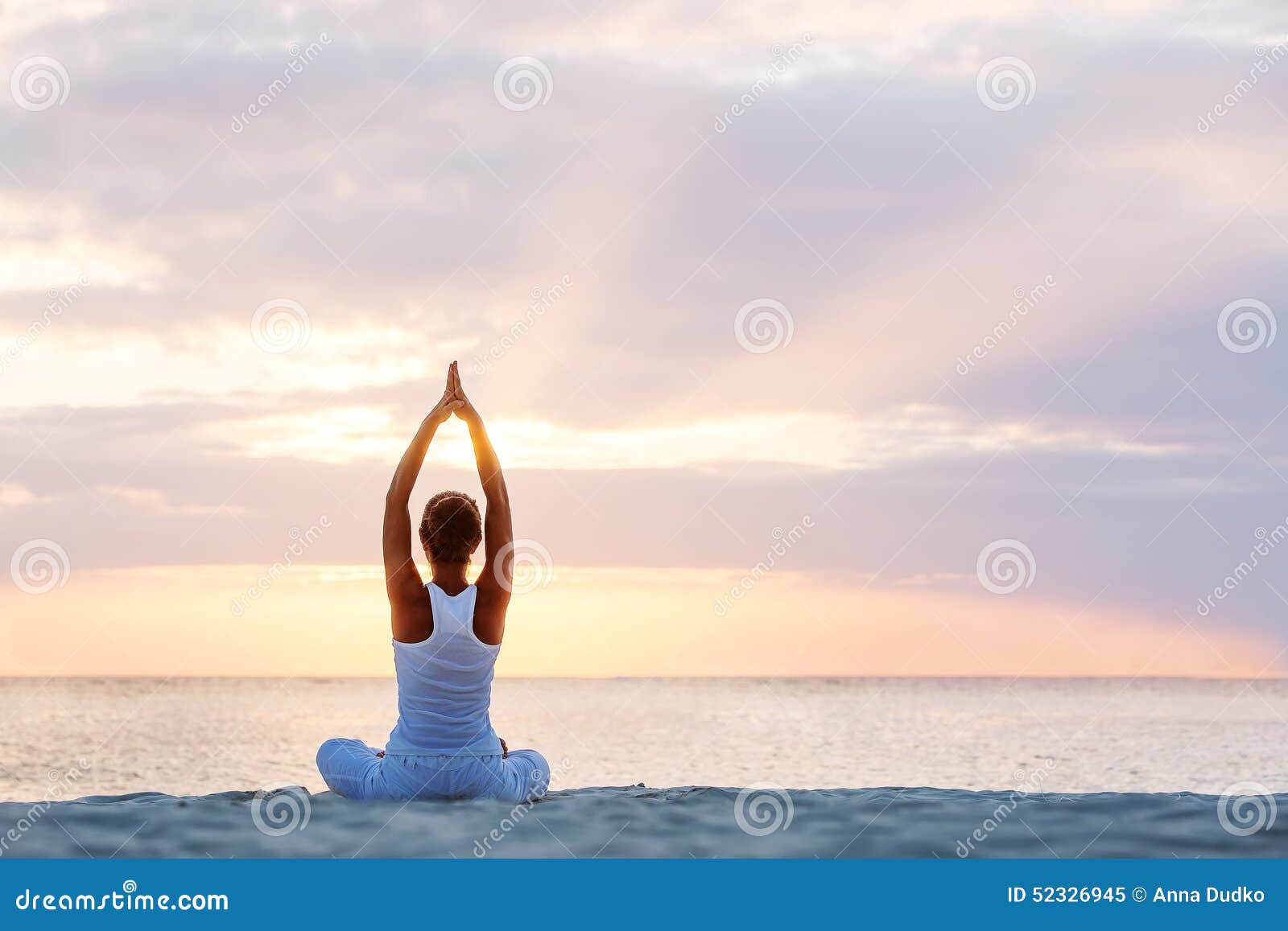 caucasian woman practicing yoga at seashore