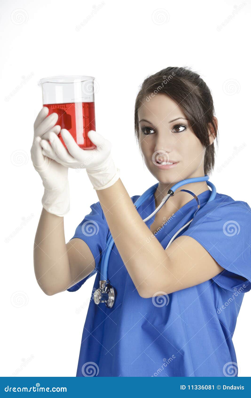 caucasian woman working as a laboratory technician studing a beaker