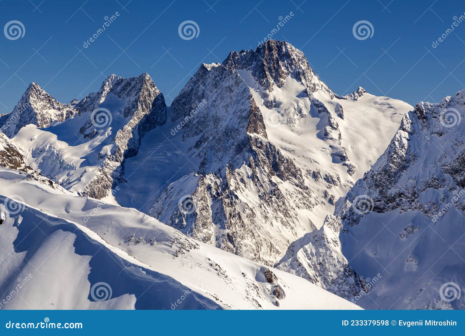 caucasus mountains, panoramic view of the ski slope with the mountains belalakaya, sofrudzhu and sulakhat on the horizon in winter