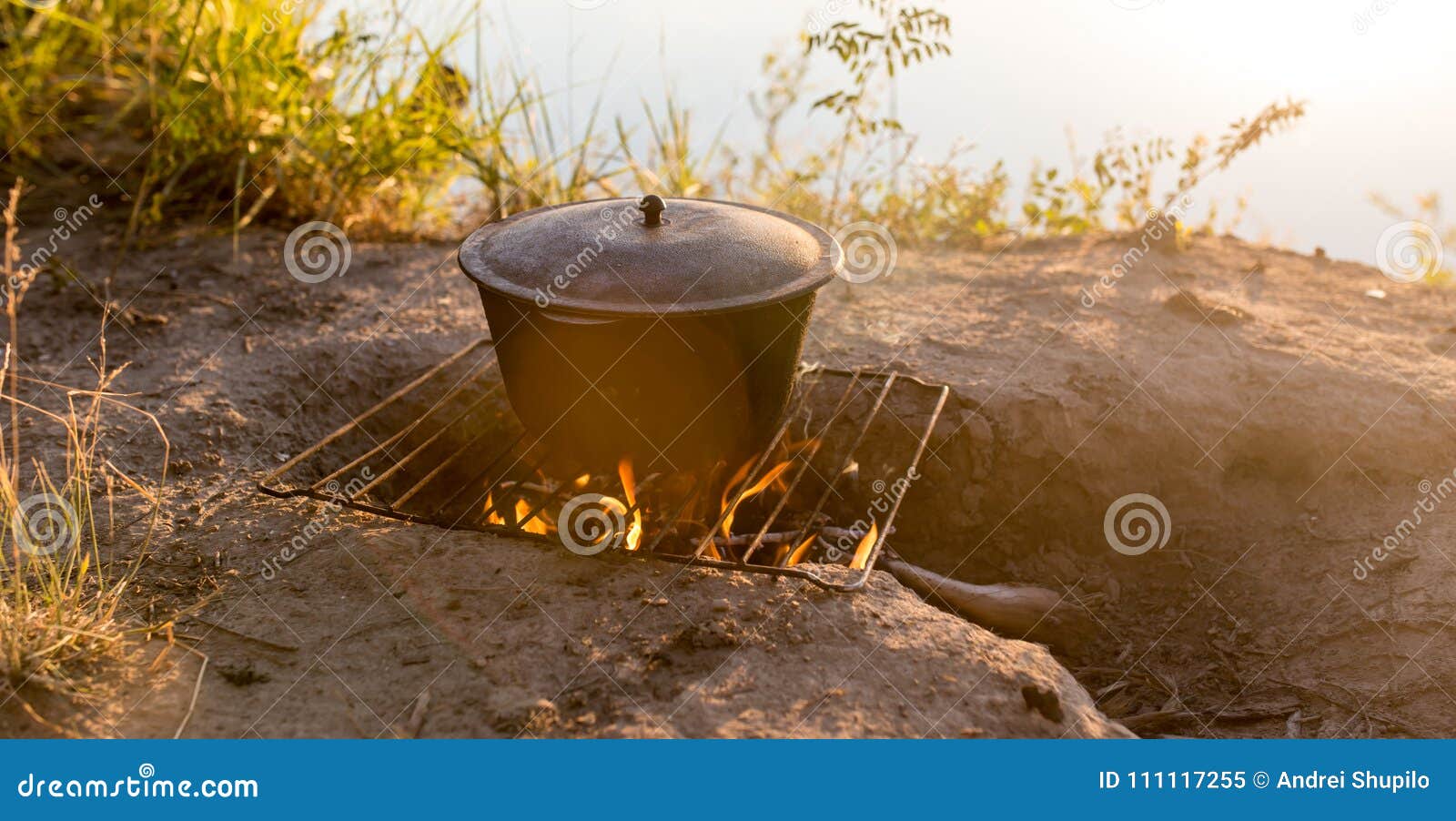 Cauldron on fire at sunset stock image. Image of firewood 111117255