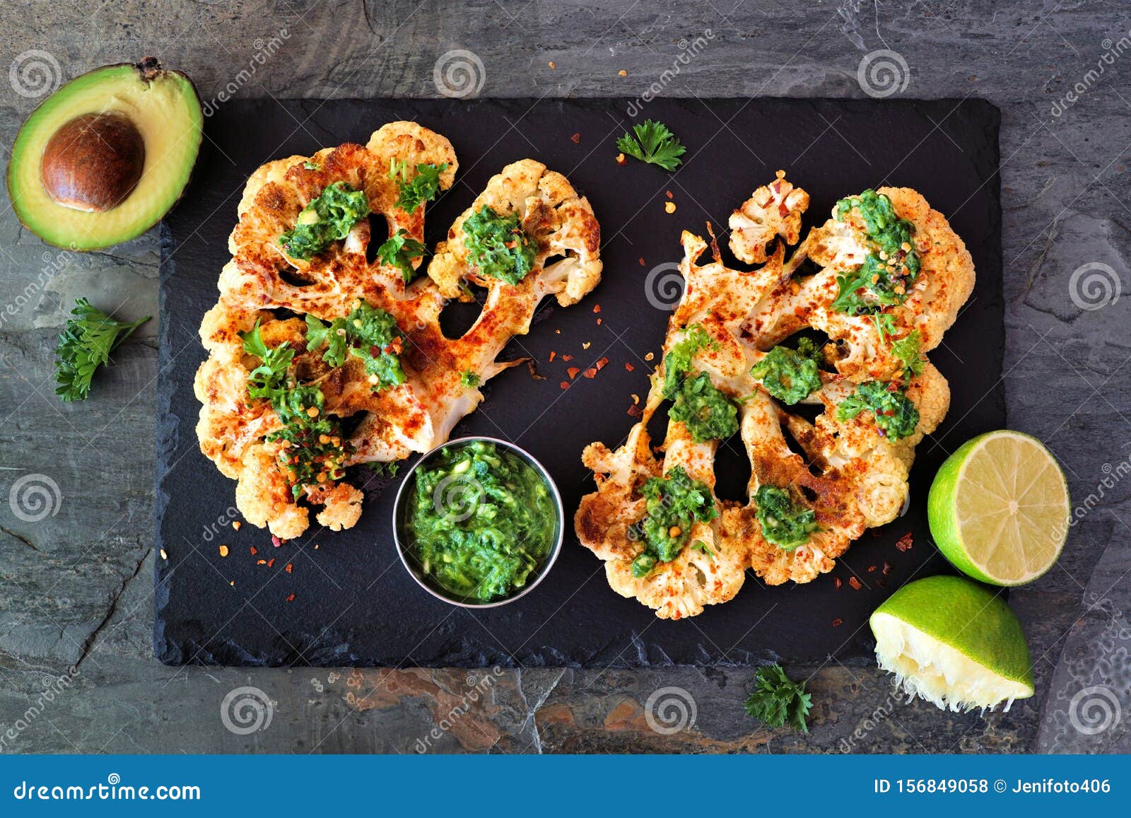 cauliflower steaks above view on a slate platter, healthy plant based meat substitute concept
