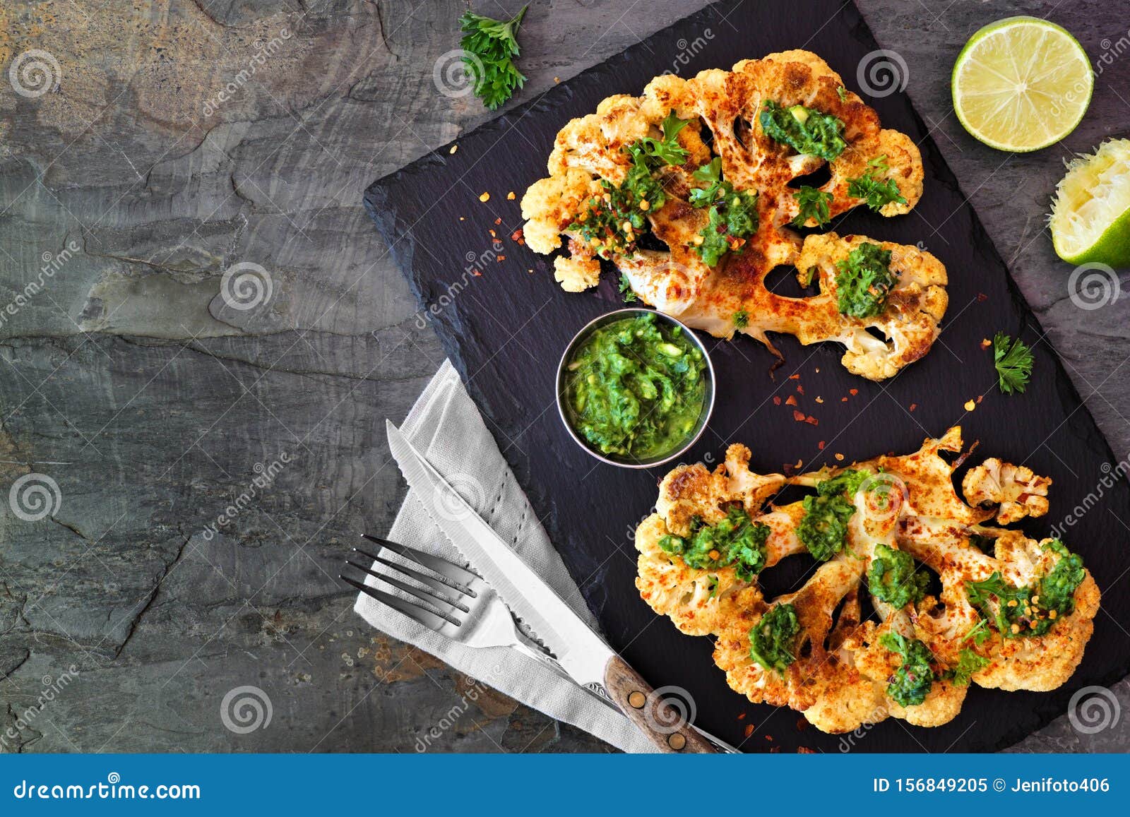 cauliflower steaks top view scene on a dark background, healthy plant based meat substitute concept