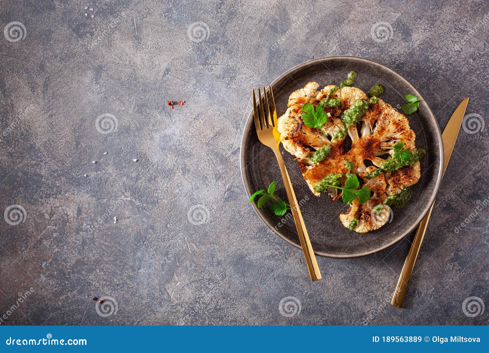 cauliflower steaks with herb sauce and spice. plant based meat substitute