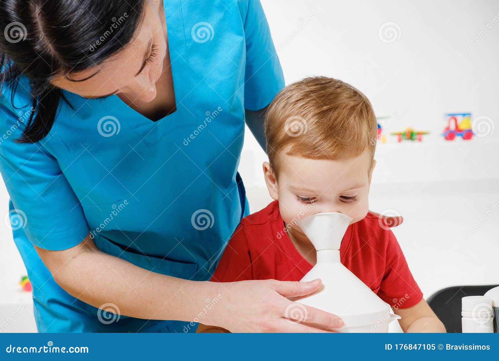 causian little boy making inhalation with nebulizer at hospital