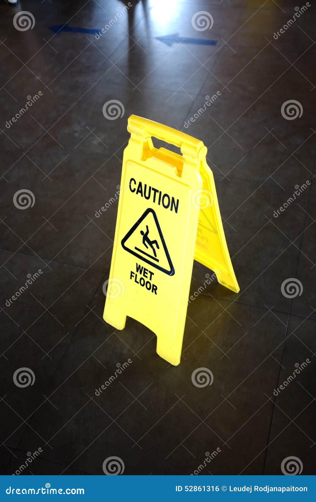 Caution Yellow Sign for Wet Floor Warning on a Floor Stock Photo