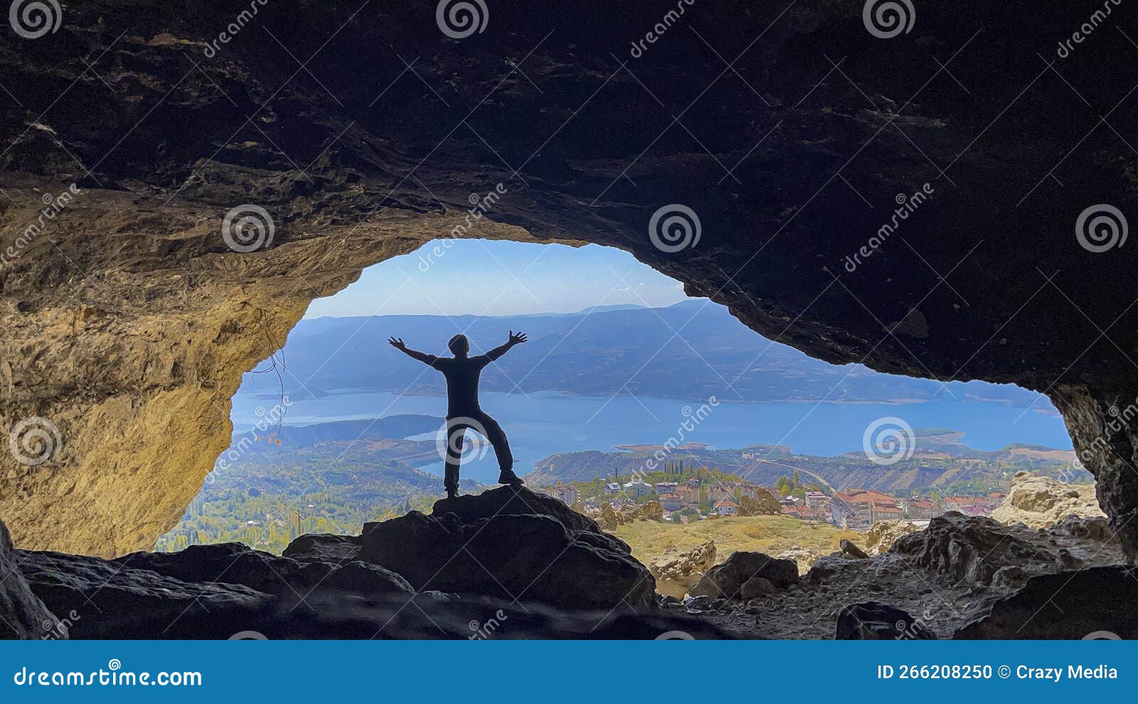 Cave Expedition in Mountains and Person Enjoying Life Stock Photo