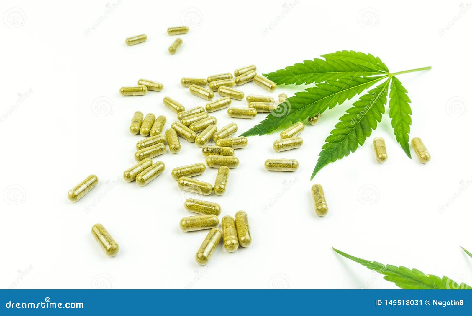 CBD Pills. Group of Clear CBD Cannabidiol Capsules and Hemp Leaf