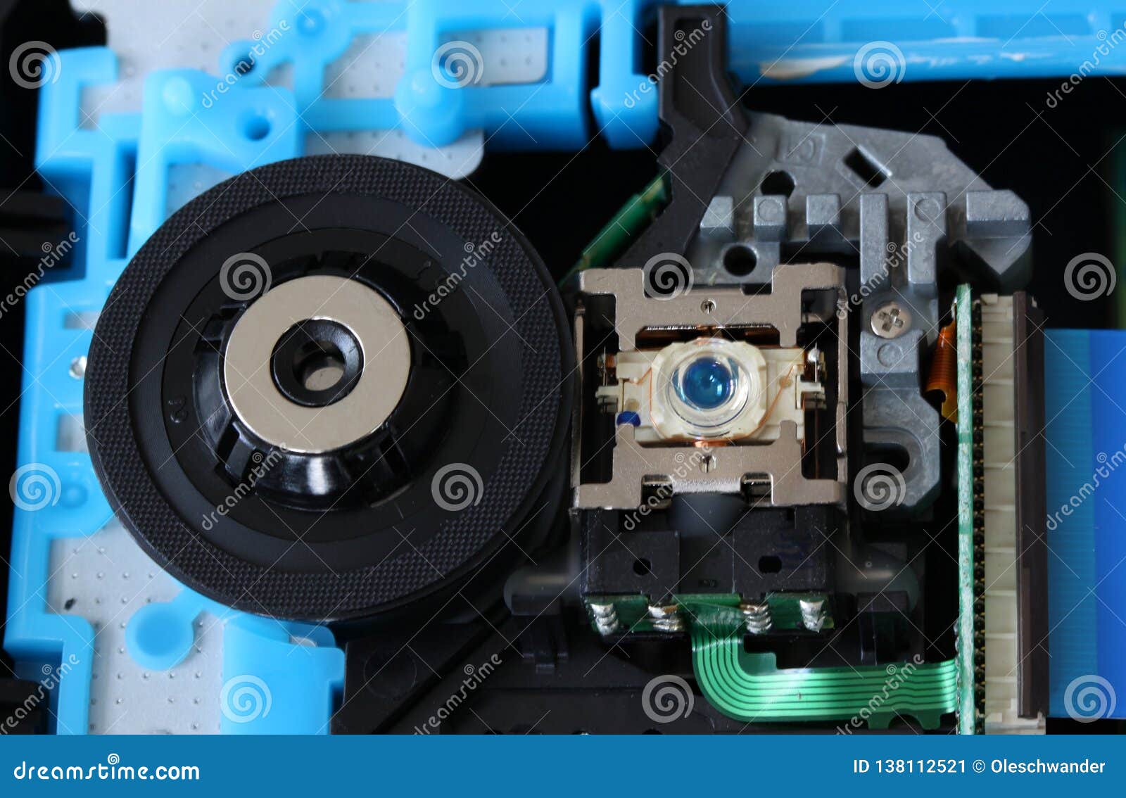 cd inside a dvd payer showing optical pick up laser lens with circuits, cables and boards - close up