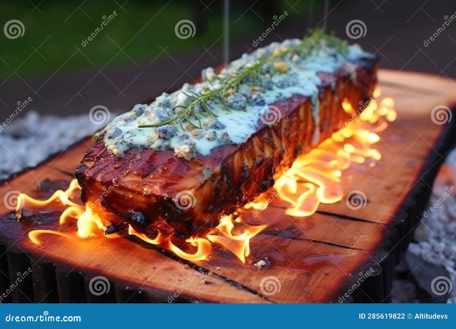 Cedar Plank with Blue Cheese and Grill Flames Underneath Stock Photo