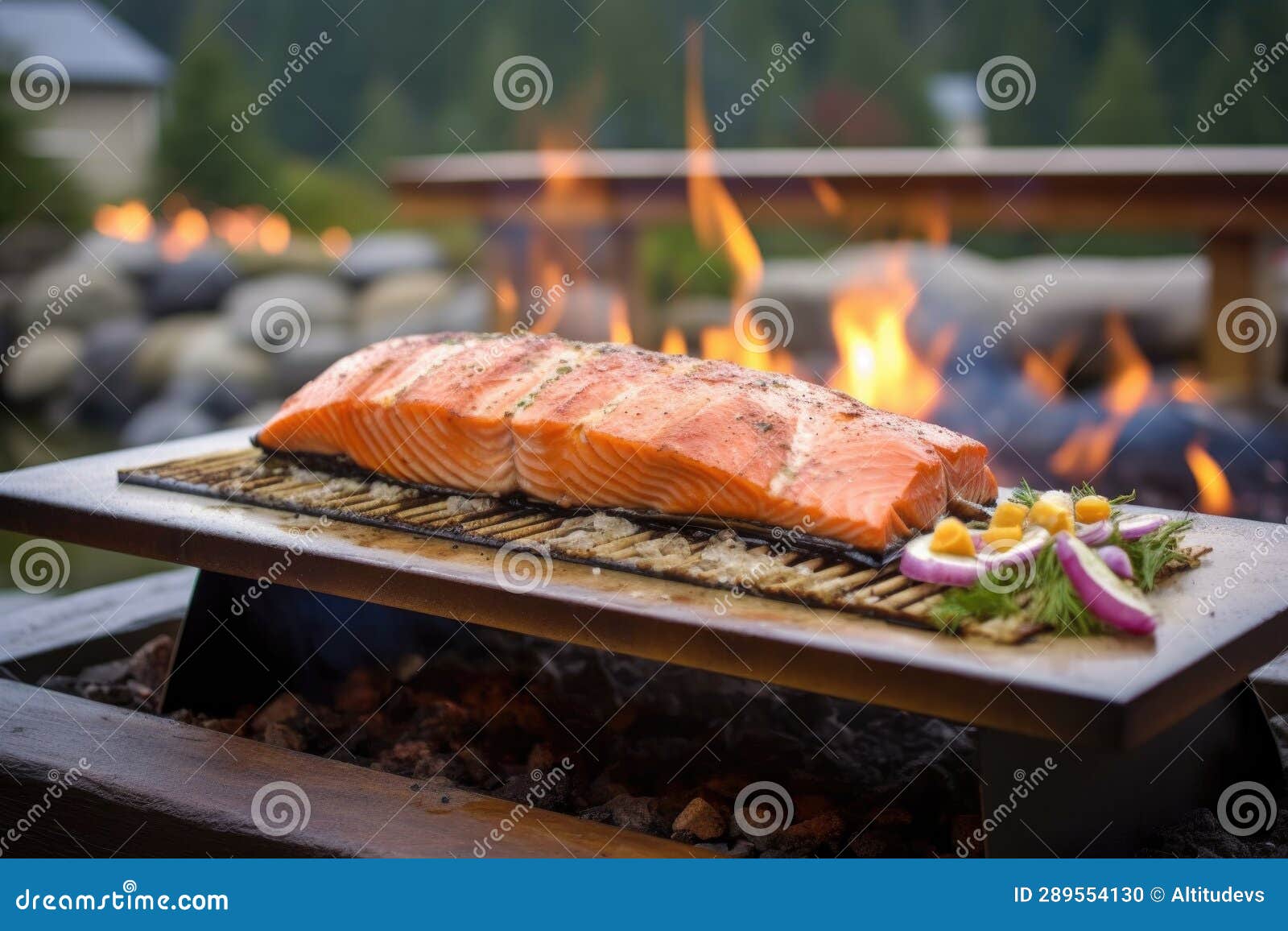 Cedar Plank Salmon with Grill Lid Open, Fire in Background Stock Photo